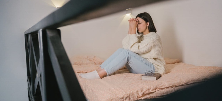 a woman praying in bed