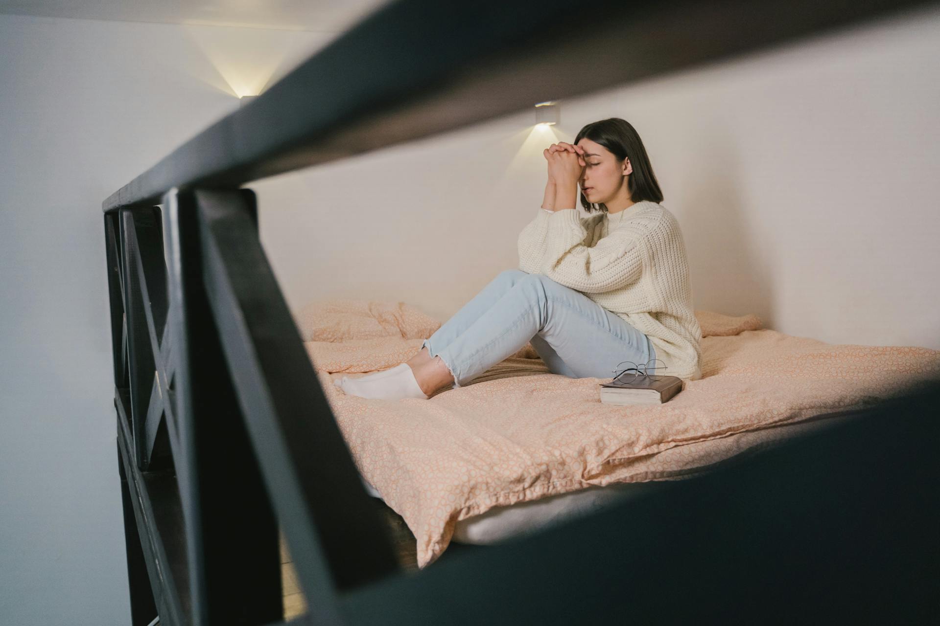 a girl praying and dealing with Addiction Relapse Warning Signs