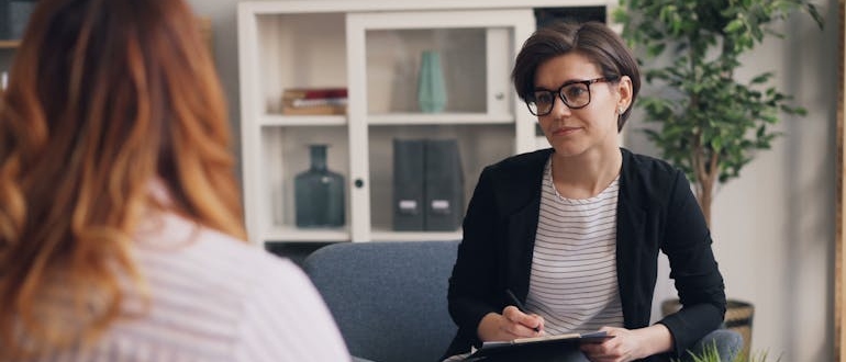 A person talking to a therapist at a Christian inpatient rehab center